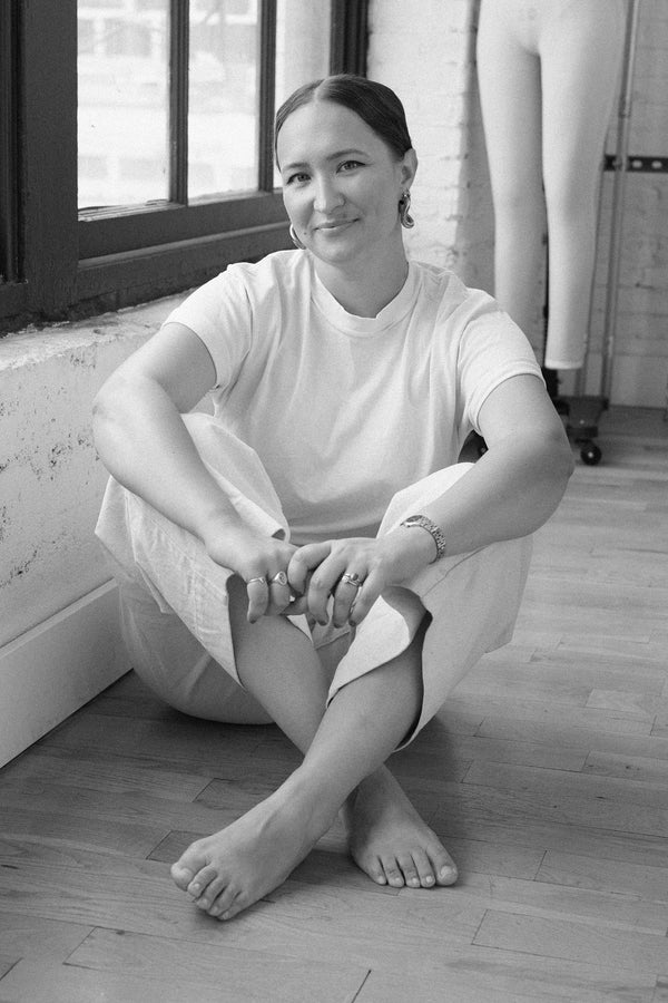 Black and white photo of founder of Daughter Judy sewing pattern company Chelsea Carson sitting on floor